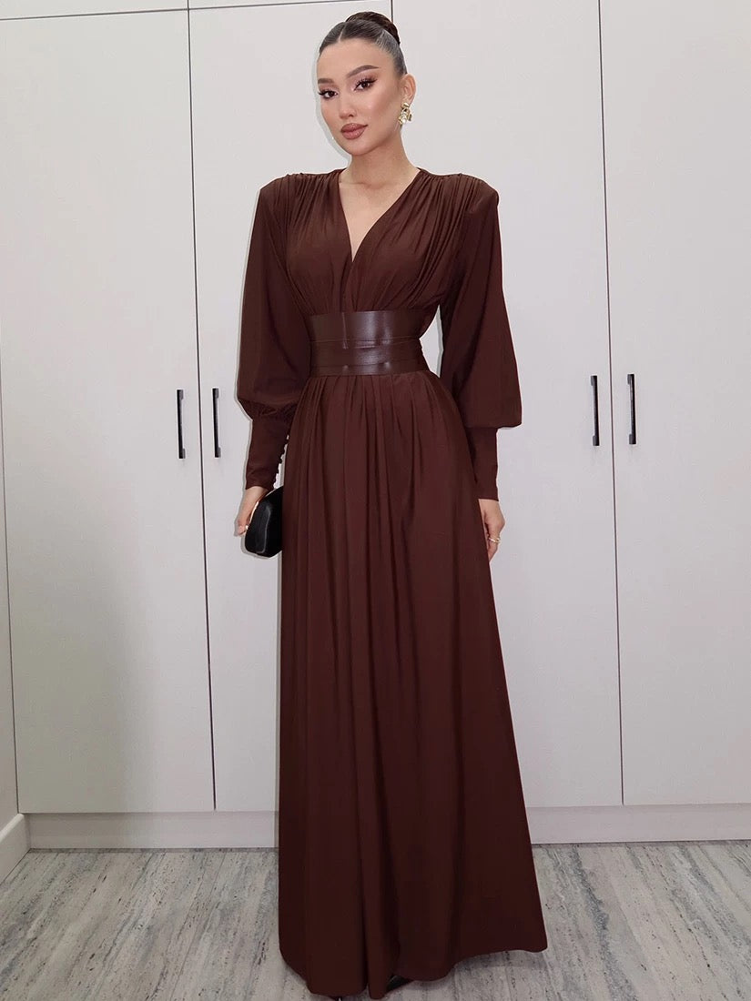 Elegant long brown dress with statement waist belt and voluminous sleeves