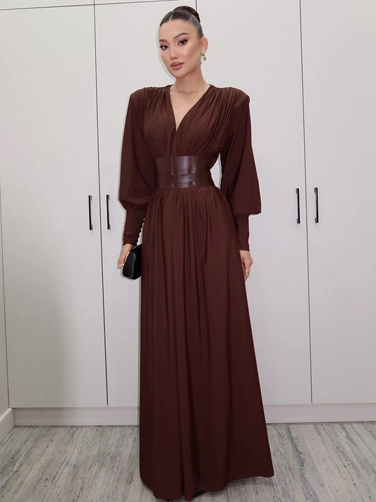 Elegant long brown dress with statement waist belt and voluminous sleeves