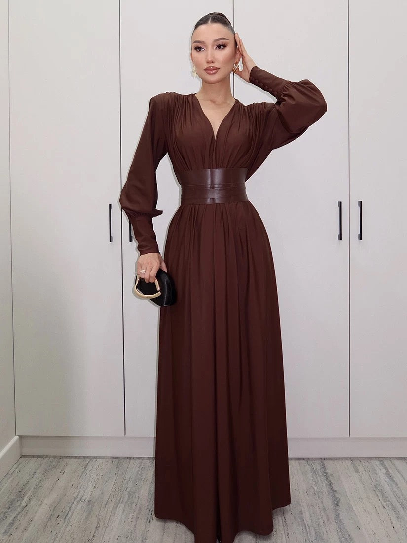 Elegant long brown dress with statement waist belt and voluminous sleeves